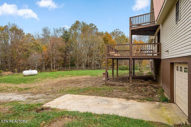 view of yard with a garage and a deck