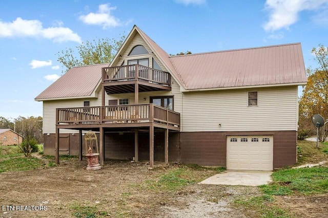 rear view of property featuring a garage and a deck