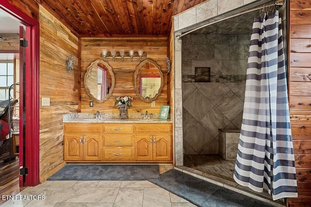 bathroom with wood walls, wooden ceiling, a shower with shower curtain, vanity, and tile patterned floors