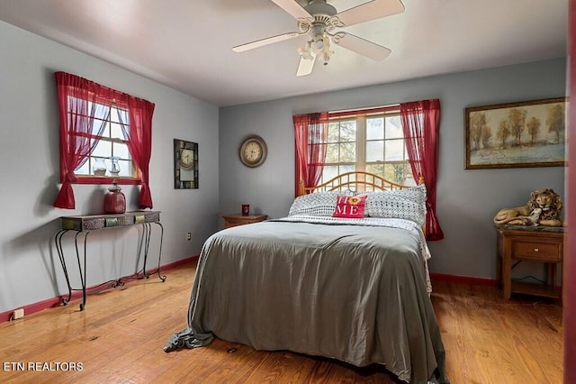 bedroom with hardwood / wood-style floors and ceiling fan