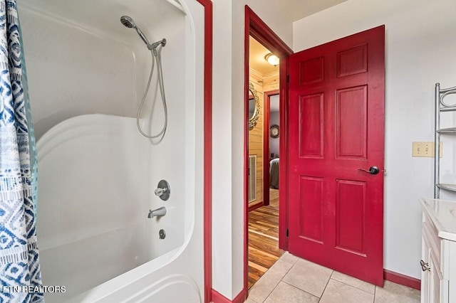 bathroom featuring hardwood / wood-style flooring, vanity, and shower / bath combination with curtain