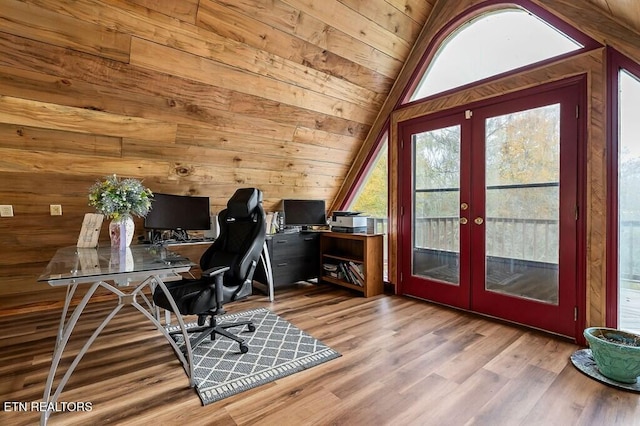 home office featuring french doors, wooden walls, lofted ceiling, wooden ceiling, and light hardwood / wood-style flooring