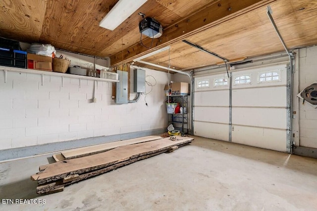 garage featuring electric panel and a garage door opener