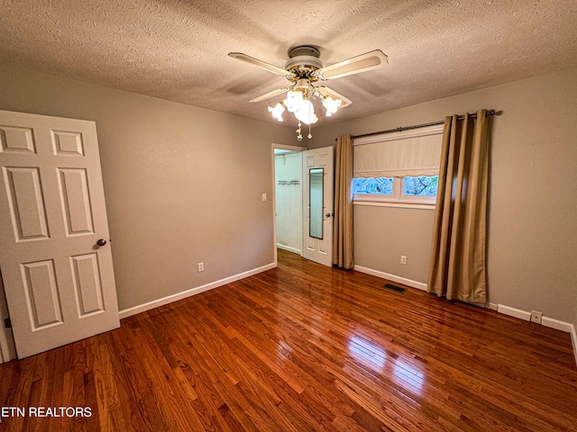 unfurnished bedroom featuring ceiling fan, a textured ceiling, and wood-type flooring