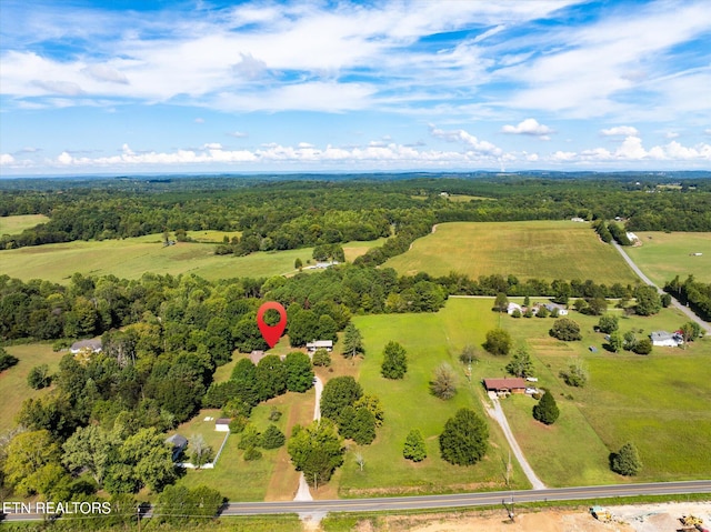 birds eye view of property with a rural view