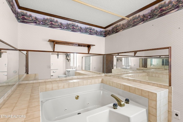 bathroom featuring a washtub, a textured ceiling, tile patterned floors, and ornamental molding