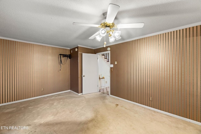 unfurnished room featuring a textured ceiling, ceiling fan, and crown molding