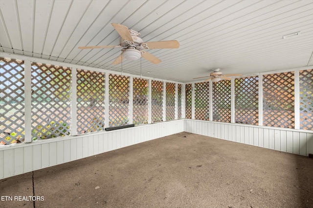 unfurnished sunroom with ceiling fan