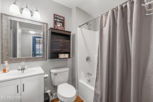 full bathroom with hardwood / wood-style floors, vanity, toilet, and shower / tub combo with curtain