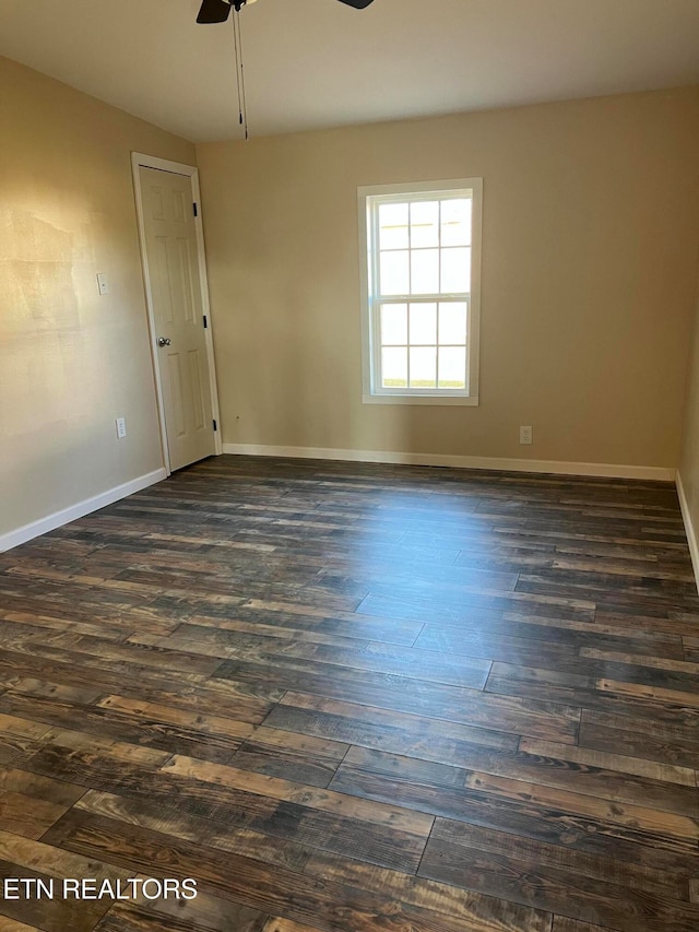 empty room featuring dark hardwood / wood-style flooring and ceiling fan