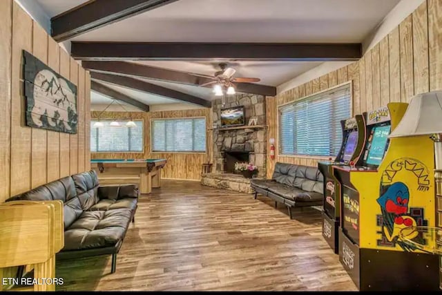 living room featuring a fireplace, wood walls, a healthy amount of sunlight, and wood-type flooring