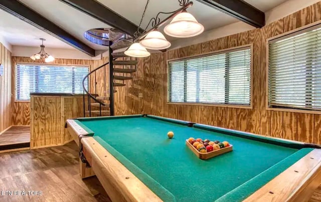 recreation room featuring a wealth of natural light, wooden walls, hardwood / wood-style flooring, and beam ceiling