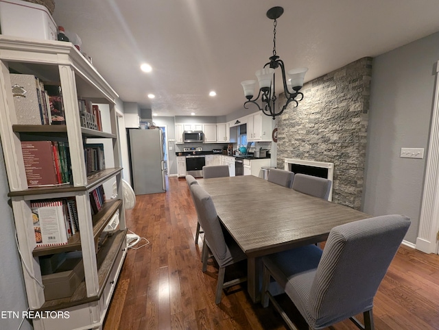 dining room featuring dark wood-type flooring and an inviting chandelier