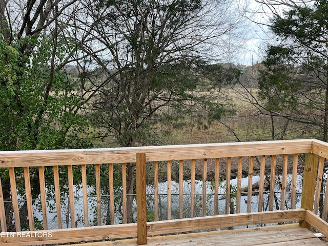 wooden deck featuring a water view