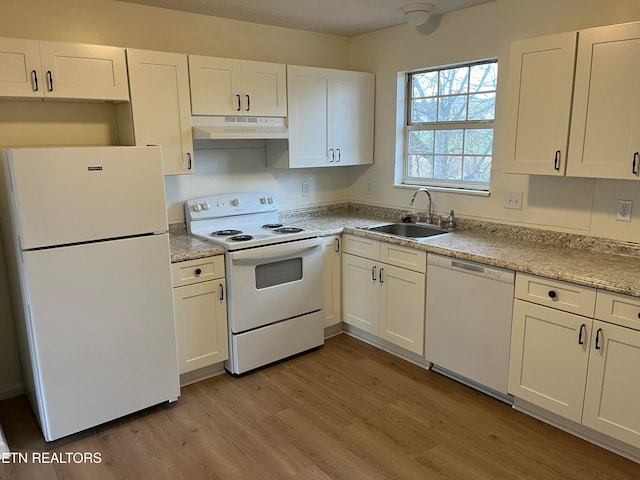 kitchen featuring white cabinetry, light wood-type flooring, sink, and white appliances