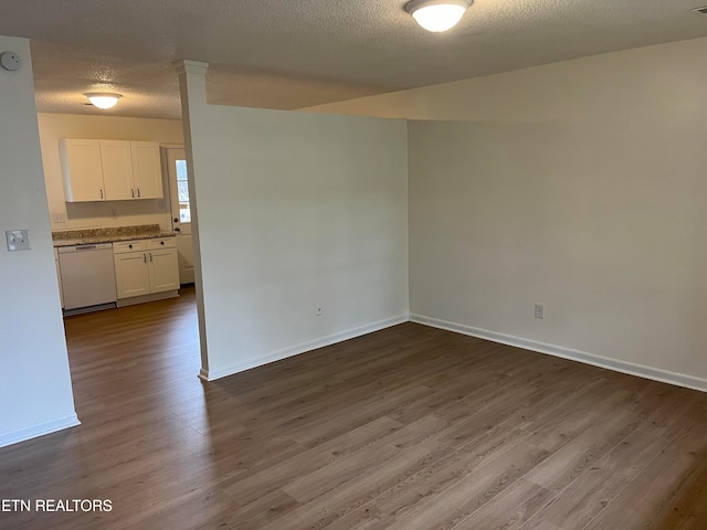 spare room featuring hardwood / wood-style floors and a textured ceiling