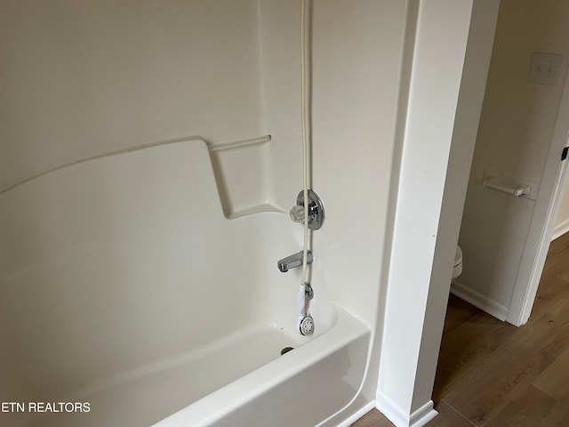 bathroom featuring hardwood / wood-style floors, independent shower and bath, and toilet