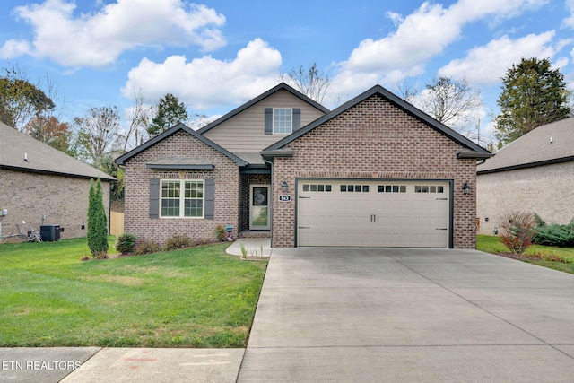 view of front of house with a garage, central AC, and a front lawn