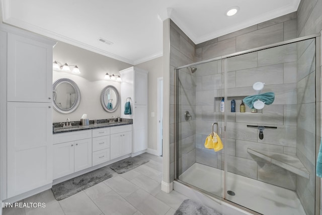 bathroom featuring vanity, a shower with door, and ornamental molding