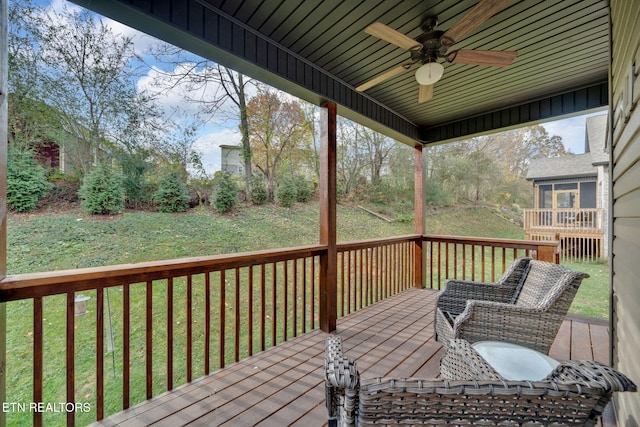 deck featuring a lawn and ceiling fan