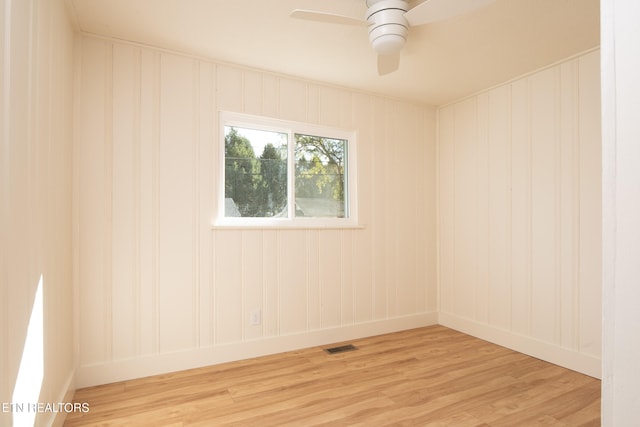 spare room with ceiling fan and light hardwood / wood-style flooring