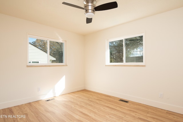 unfurnished room with light hardwood / wood-style flooring, a healthy amount of sunlight, and ceiling fan