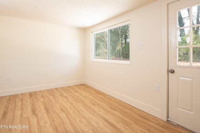 unfurnished room with light hardwood / wood-style flooring and a healthy amount of sunlight