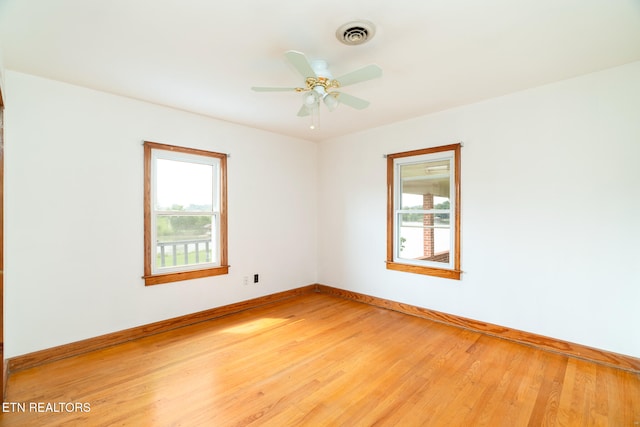 unfurnished room with hardwood / wood-style floors and ceiling fan