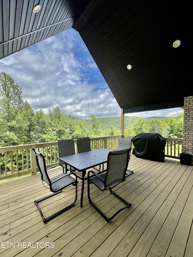 139 Pool Rd, Lafollette, TN 37766 - wooden terrace featuring grilling area, outdoor dining area, and a wooded view