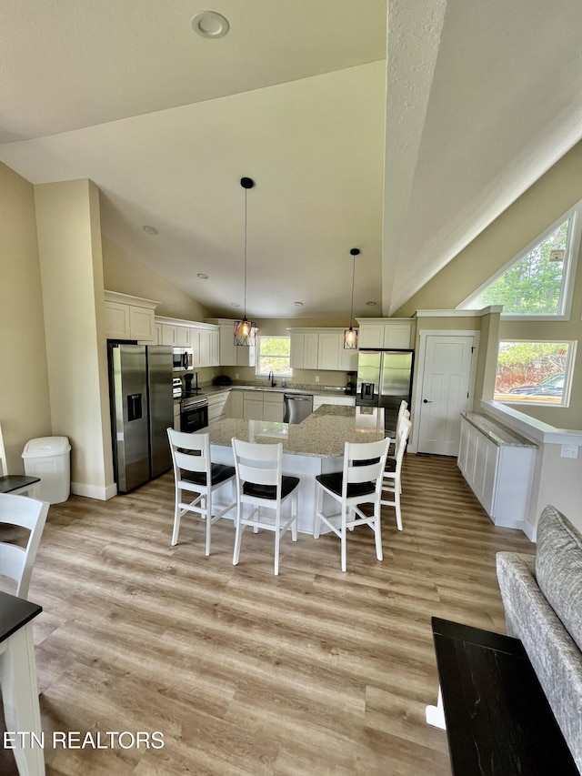 139 Pool Rd, Lafollette, TN 37766 - dining room with lofted ceiling, light wood-style flooring, and recessed lighting