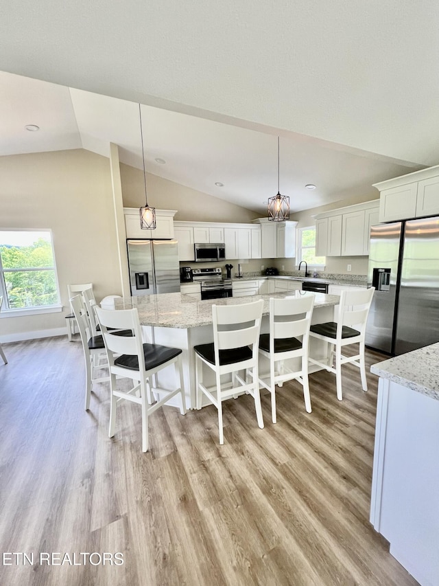 139 Pool Rd, Lafollette, TN 37766 - kitchen with stainless steel appliances, vaulted ceiling, light wood-style floors, white cabinets, and recessed lighting
