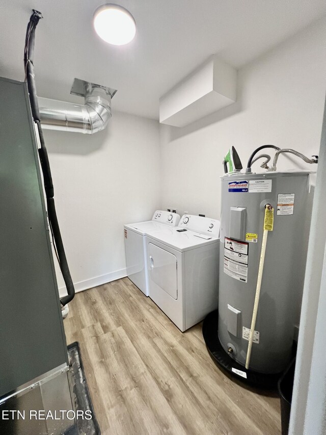 139 Pool Rd, Lafollette, TN 37766 - laundry room featuring water heater, washing machine and dryer, and light wood-style flooring
