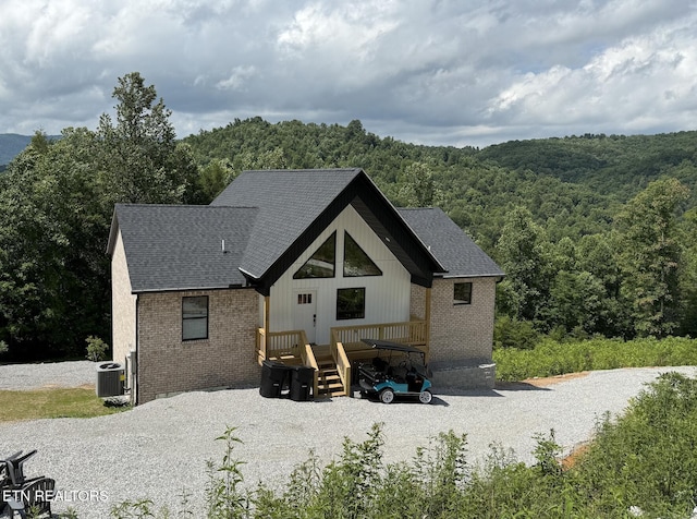139 Pool Rd, Lafollette, TN 37766 - back of house with brick siding, a forest view, and roof with shingles