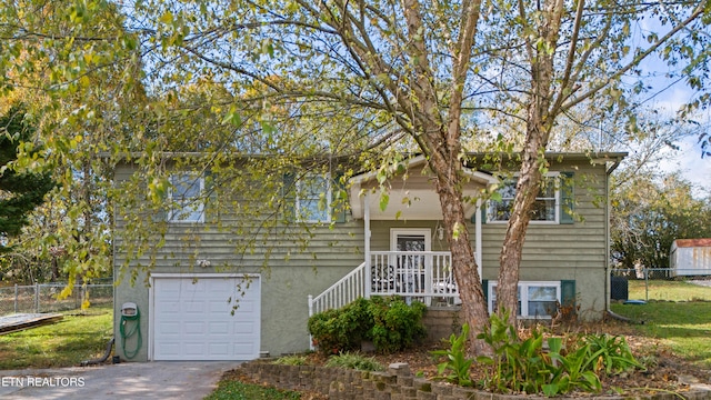 bi-level home with a garage and a porch