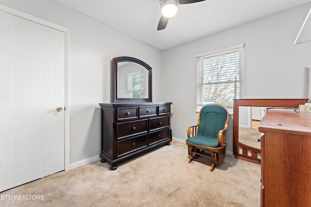 sitting room featuring ceiling fan and light colored carpet