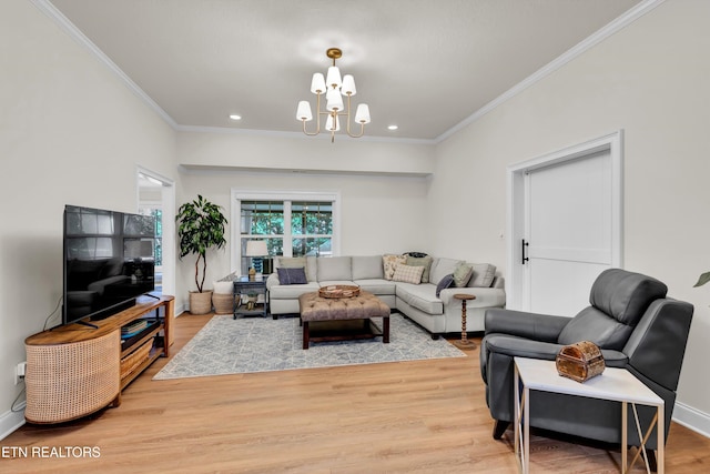 living room featuring wood-type flooring, crown molding, and an inviting chandelier