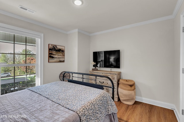 bedroom with hardwood / wood-style floors and crown molding