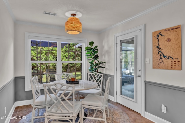 dining room featuring crown molding