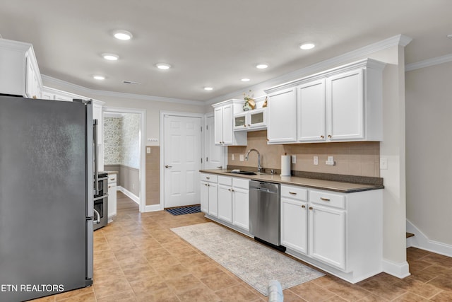 kitchen with white cabinets, crown molding, sink, decorative backsplash, and appliances with stainless steel finishes