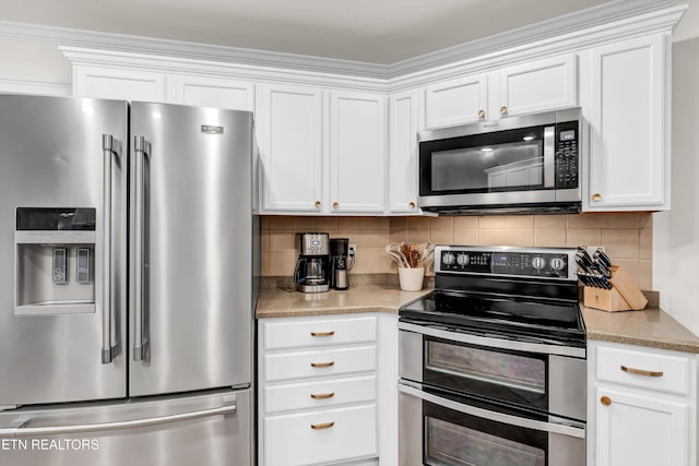 kitchen with white cabinets, stainless steel appliances, and tasteful backsplash