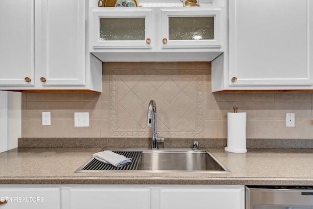 kitchen with white cabinets, tasteful backsplash, and sink