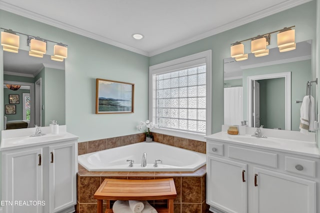 bathroom with vanity, tiled bath, and crown molding