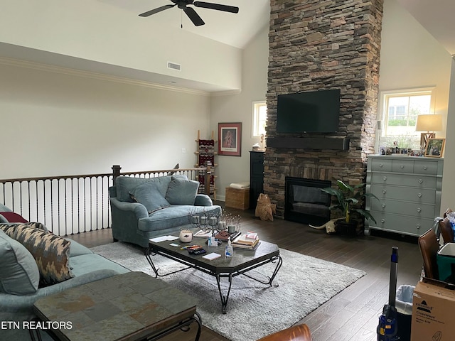 living room with high vaulted ceiling, hardwood / wood-style floors, ceiling fan, and a fireplace