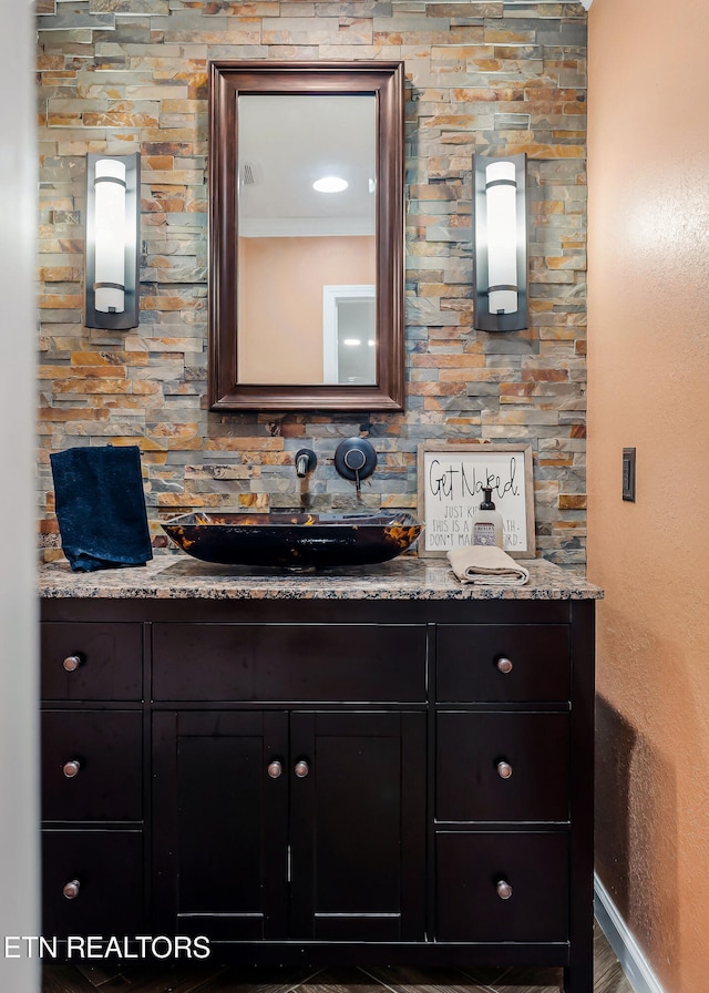 bathroom featuring wood-type flooring, vanity, and crown molding