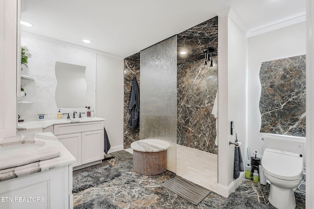 bathroom with ornamental molding, a tile shower, vanity, toilet, and tile walls