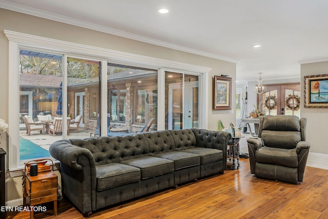 living room featuring hardwood / wood-style floors, french doors, and crown molding