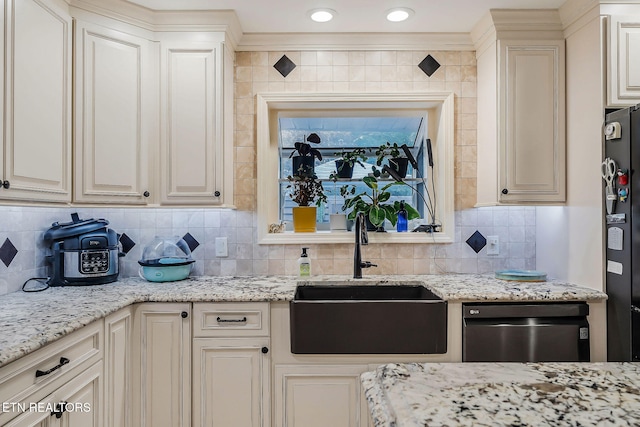 kitchen with dishwasher, sink, backsplash, and fridge