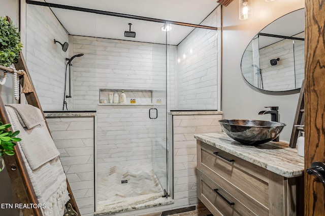 bathroom with vanity and a shower with door