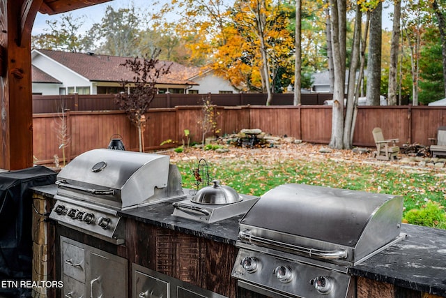 view of patio featuring an outdoor kitchen and a grill