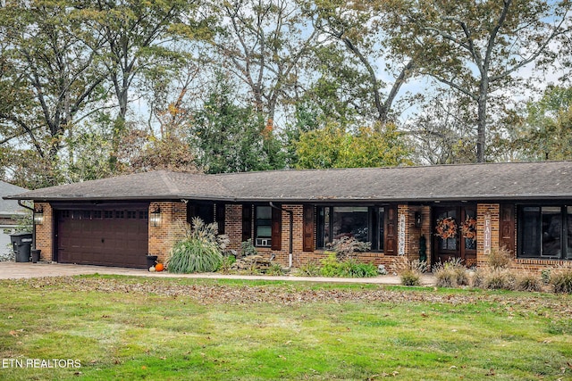 ranch-style house with a garage and a front lawn